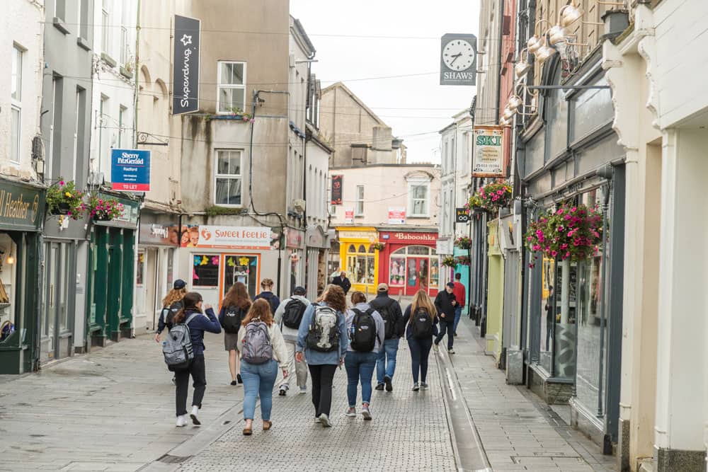 students walking down historic Ireland town center
