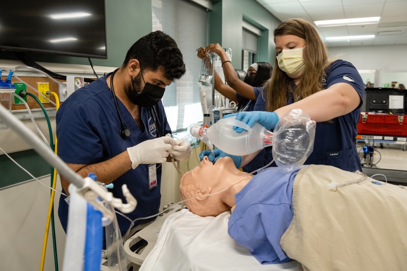two students working in a hospital simulation lab Tracheal intubation